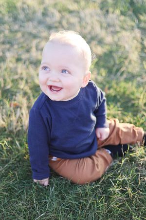 Baby smiling and giggling in the park/grass.