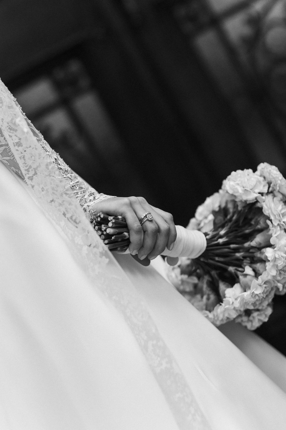 A series of black and white close-up photos showing a wedding dress and bouquet details.