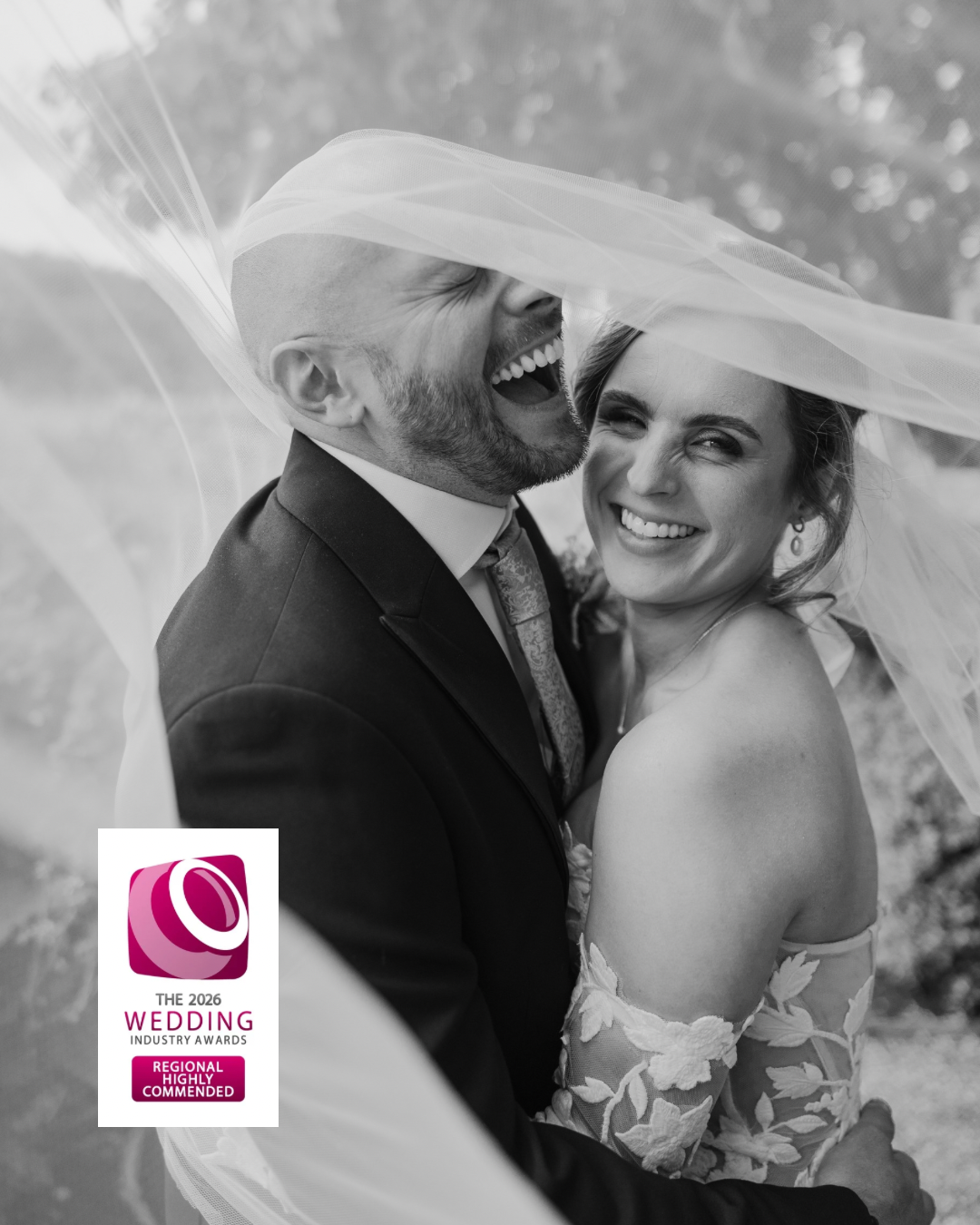 Black and white wedding portrait showing tender romantic moments between newlyweds under a veil.