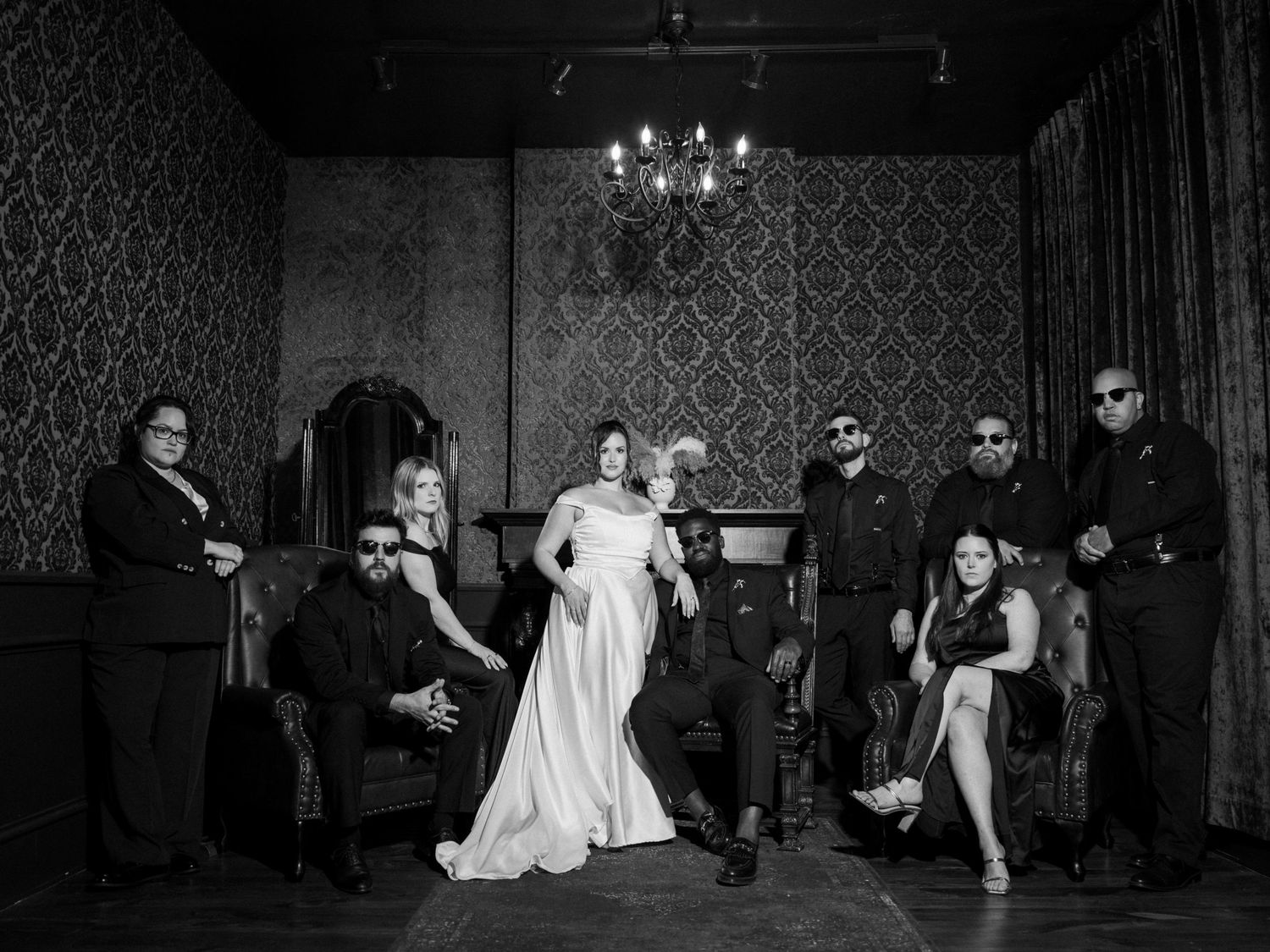 Wedding guests celebrate and dance together during a lively reception party with sparklers and confetti.