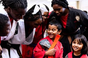 Students laugh and smile together during a joyful moment at school.