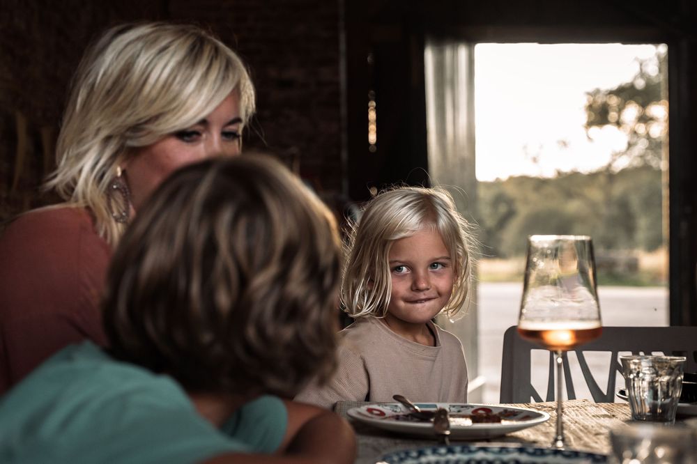 Warm sunlight streams through windows onto a dining scene.