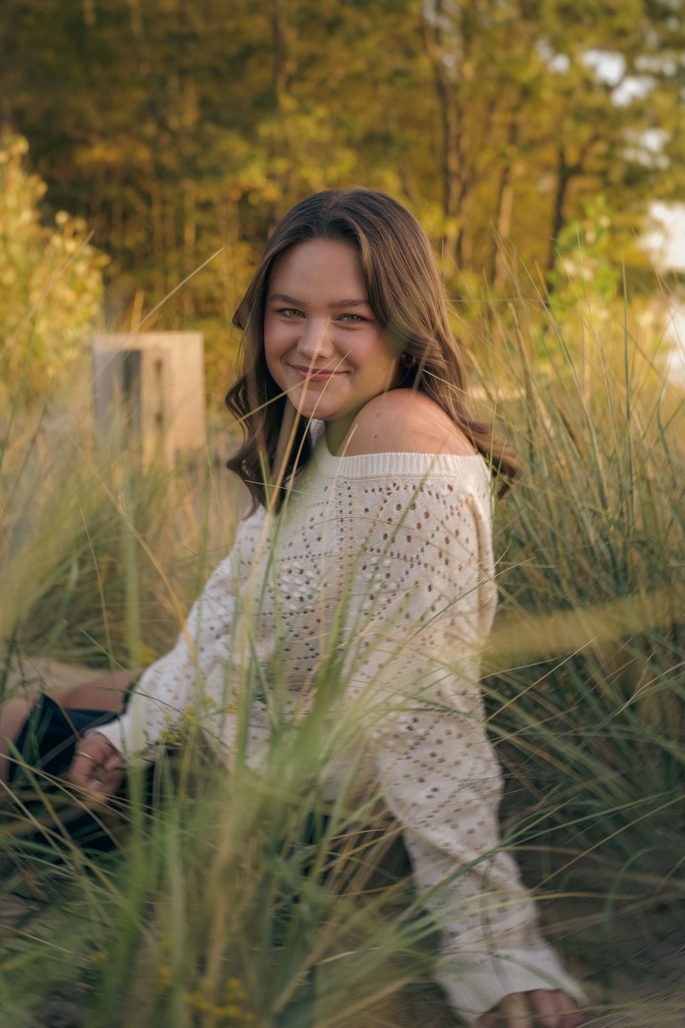 A series of outdoor portrait photos featuring someone in a cream-colored lace sweater among tall grasses at golden hour.