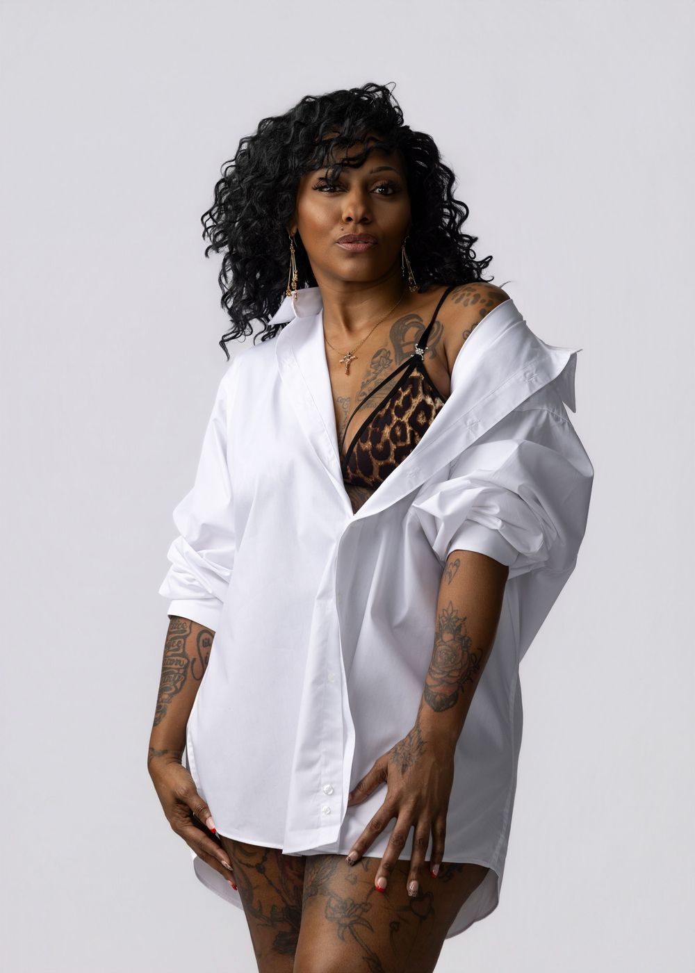 Four fashion photos showing a model in a crisp white button-down shirt against a light gray background.