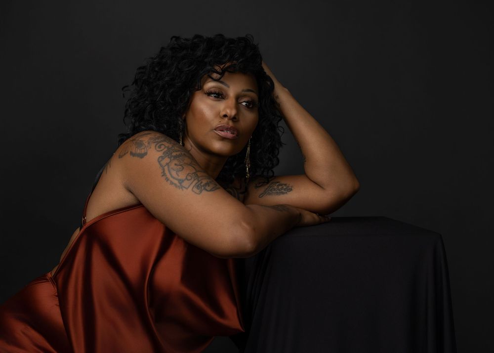 A series of dark, moody portrait photographs showing someone in a red garment against a black background.