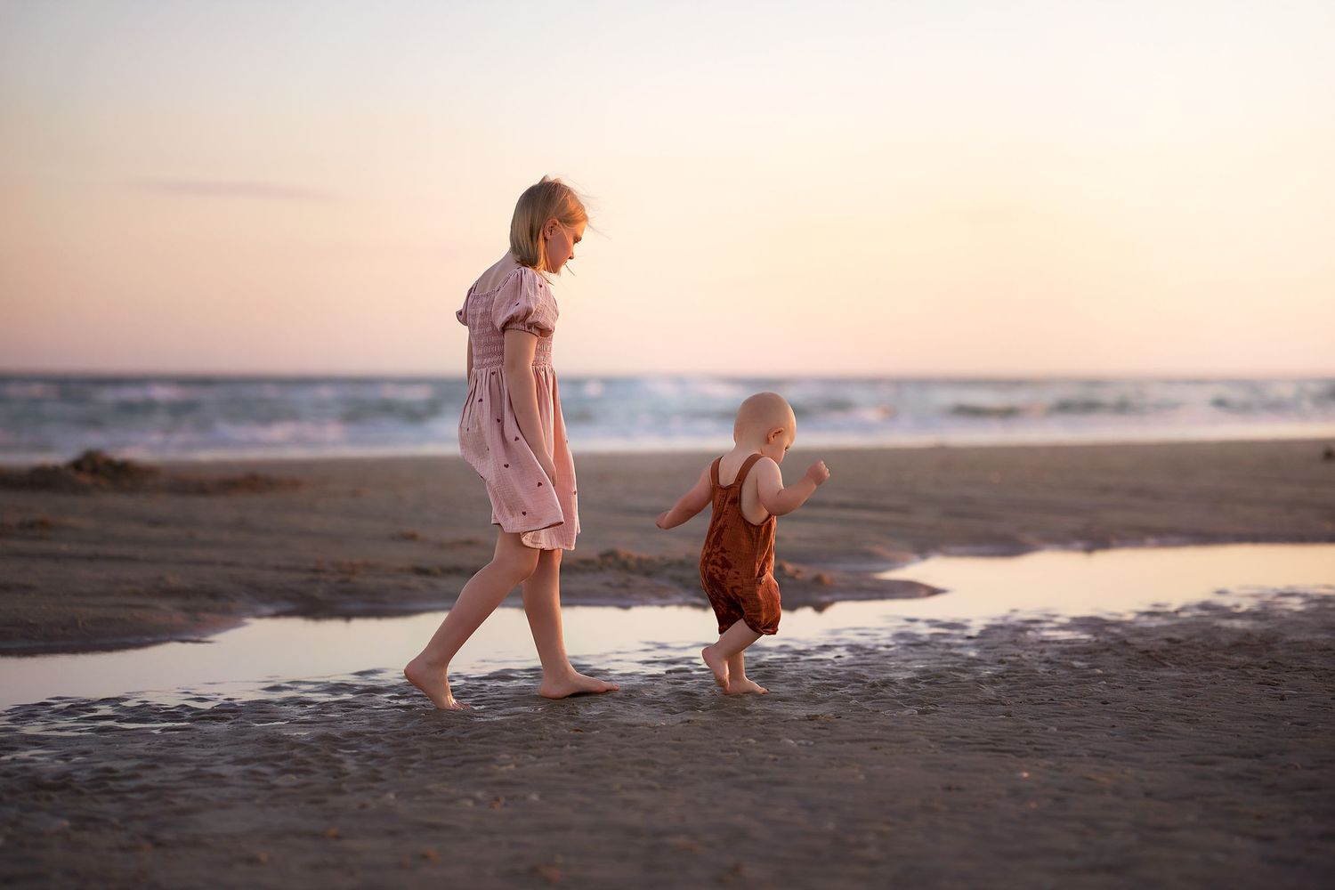 Two children walking down the beach at Matagorda Beach during a Matagorda Vacation Sunset Beach Photography Session.