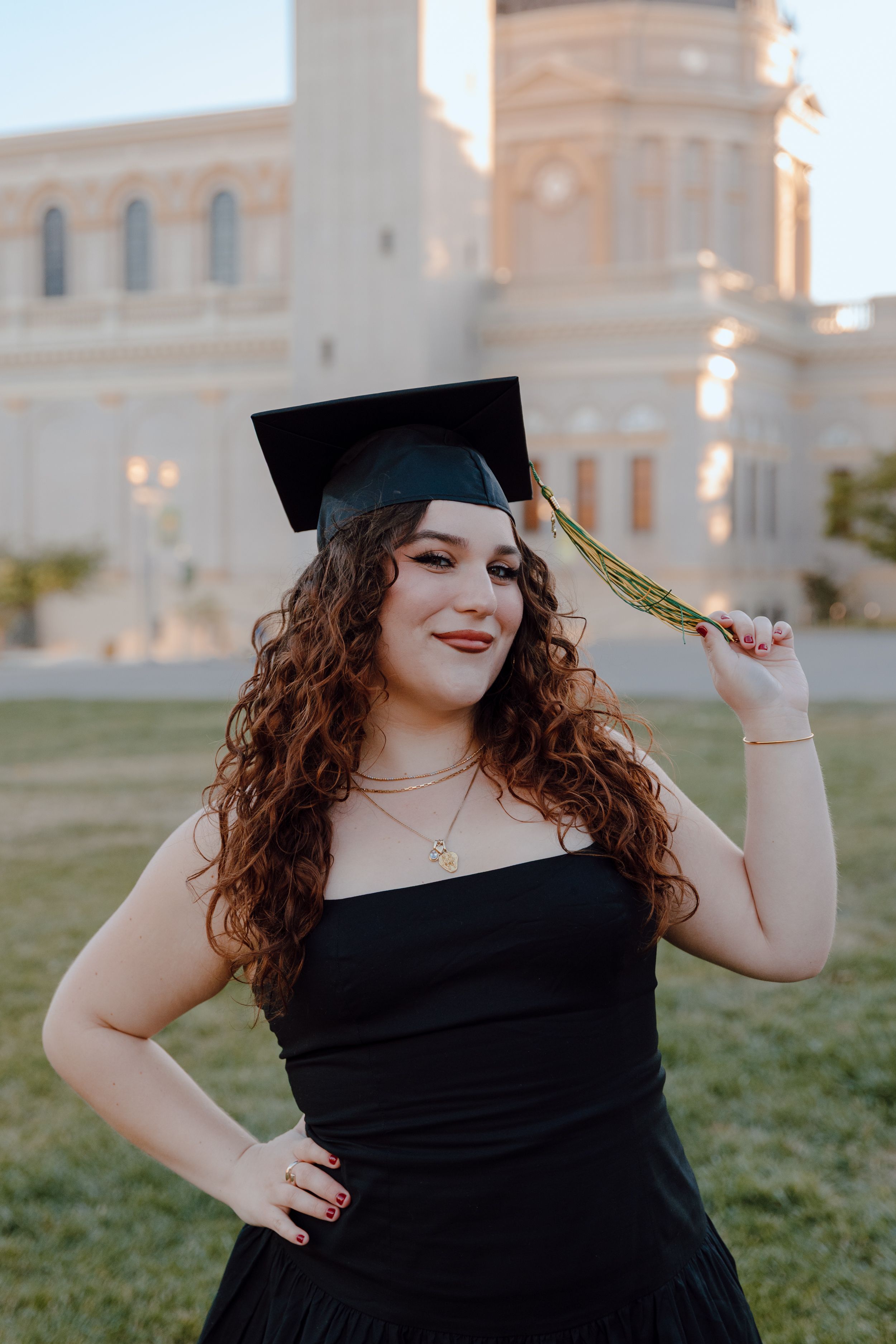 Graduate in cap holds her tassel in a close up at Ignatius Church at the University of San Francisco. By Bay Area Graduation Photographer.