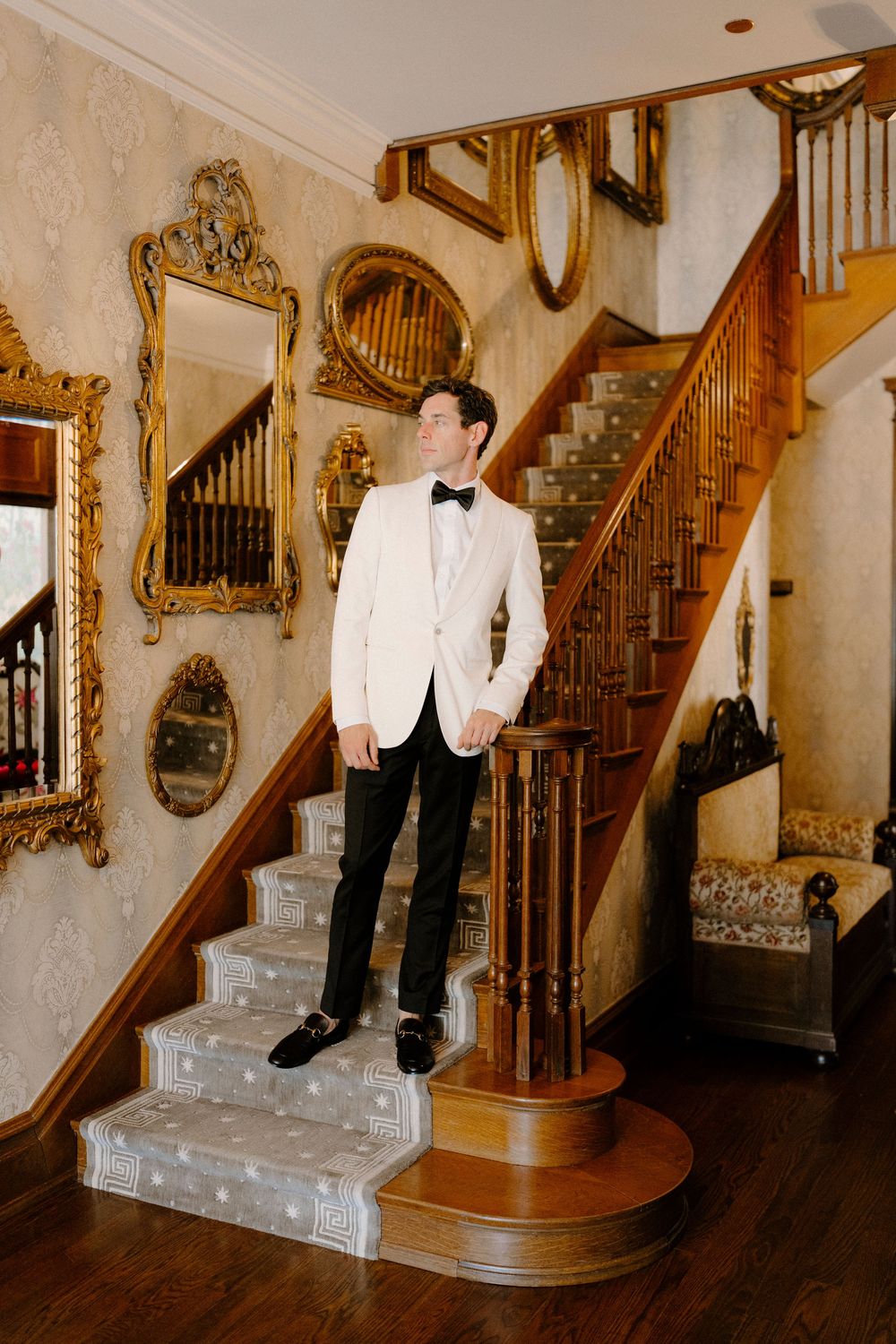 A sequence of photos showing someone in formal attire playfully sliding down an elegant wooden staircase banister.