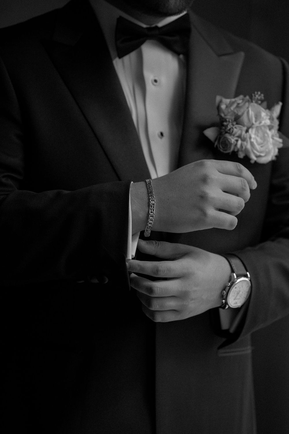 Close-up black and white photos show hands adjusting suit jacket sleeves and cuffs in formal attire.