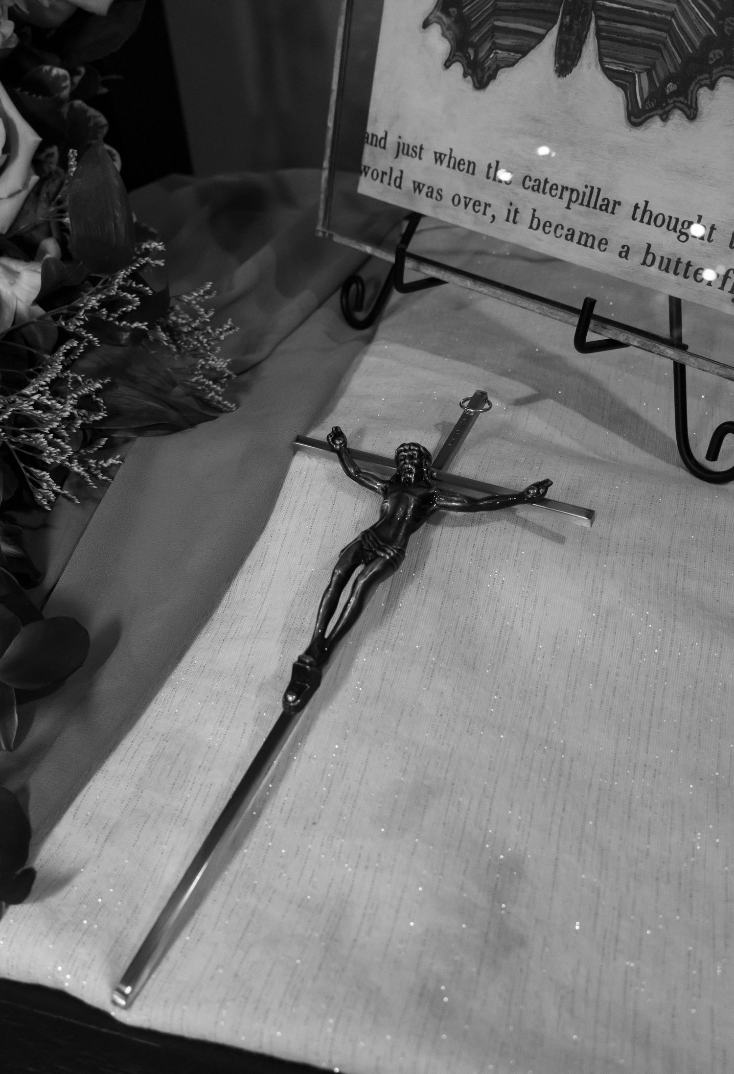 Black and white photo of a cross with Jesus on it