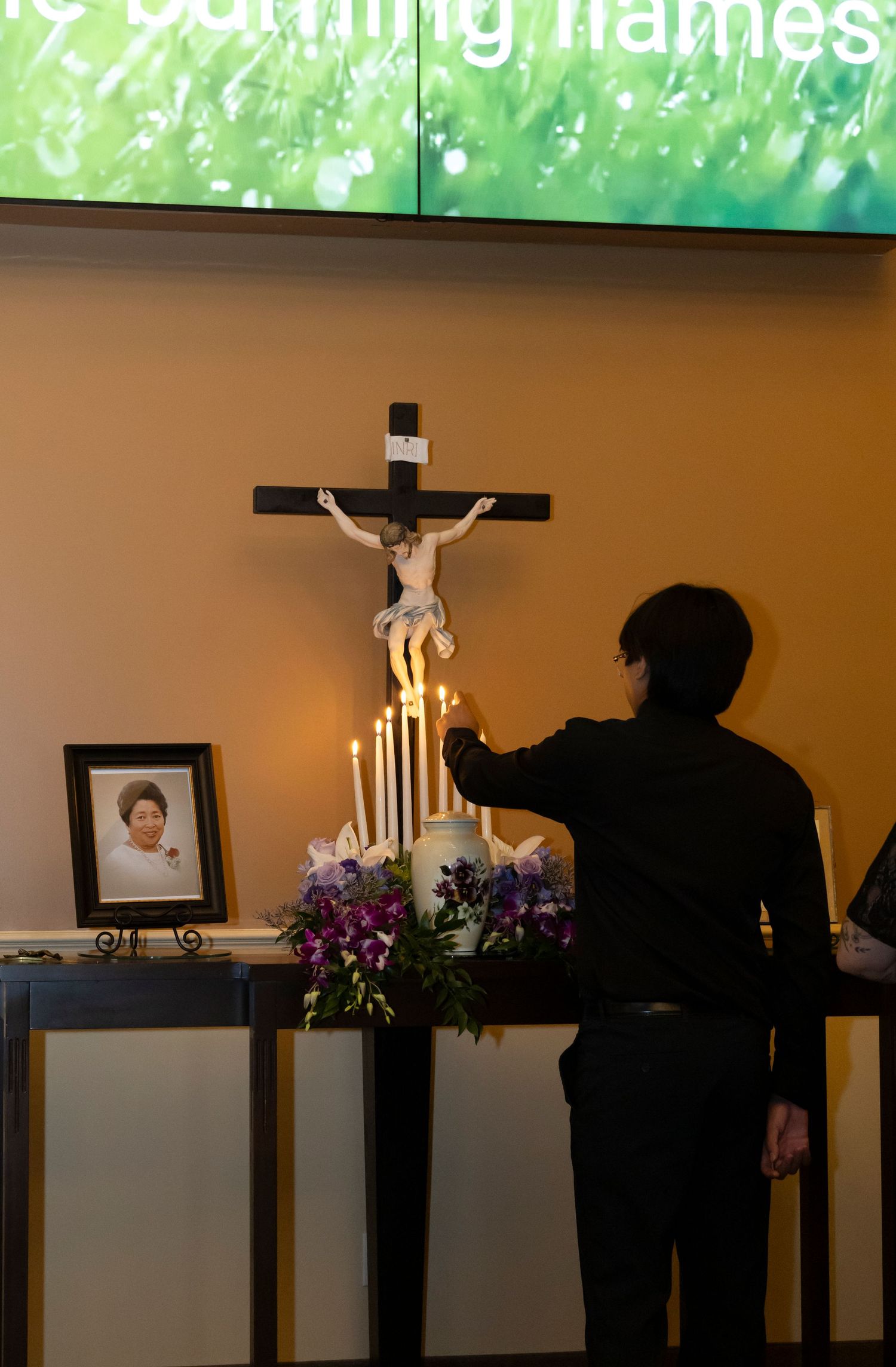 Urn photo with candles being lit by person