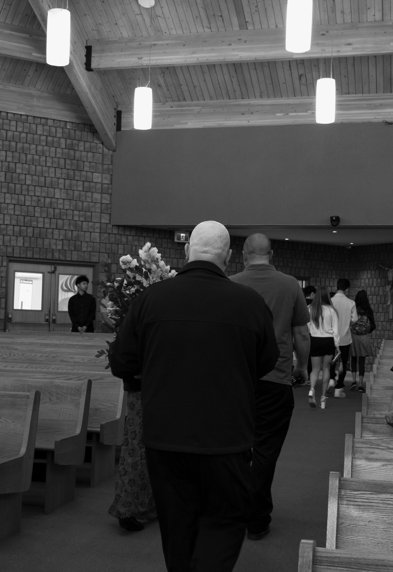 Black and white photo of man walking away