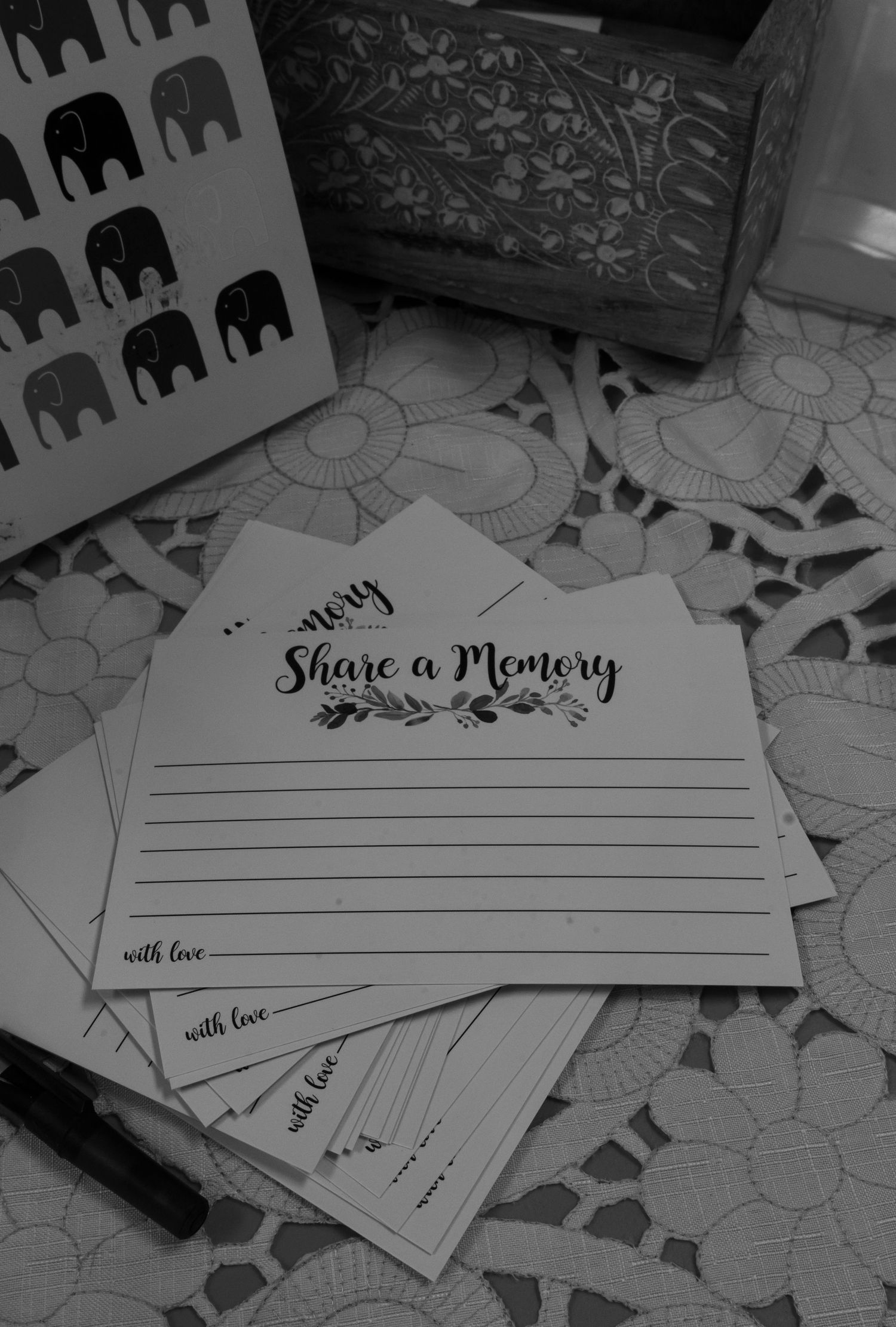 Black and white photo of "share a memory" cards