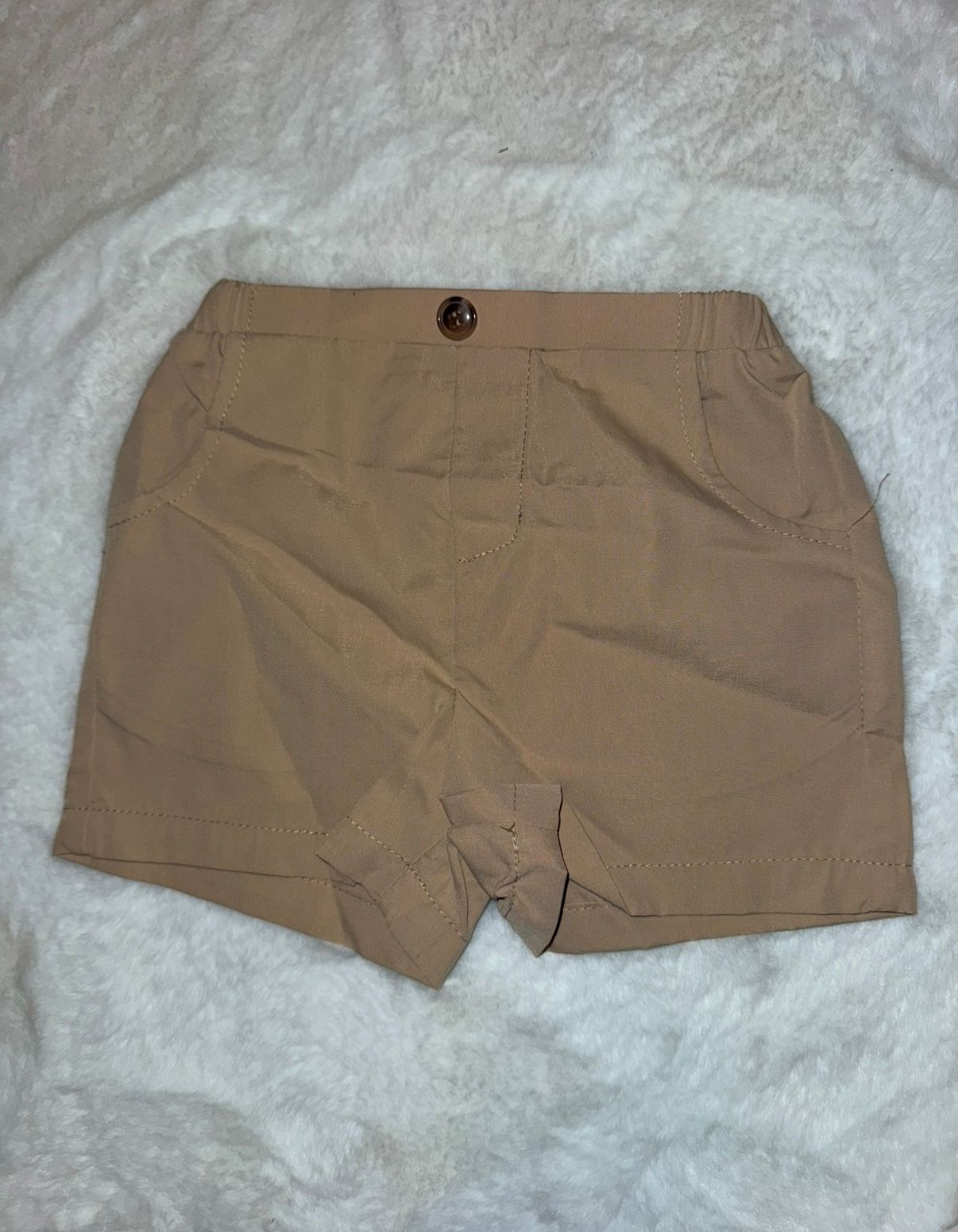 Khaki colored casual shorts with button closure displayed on white surface.