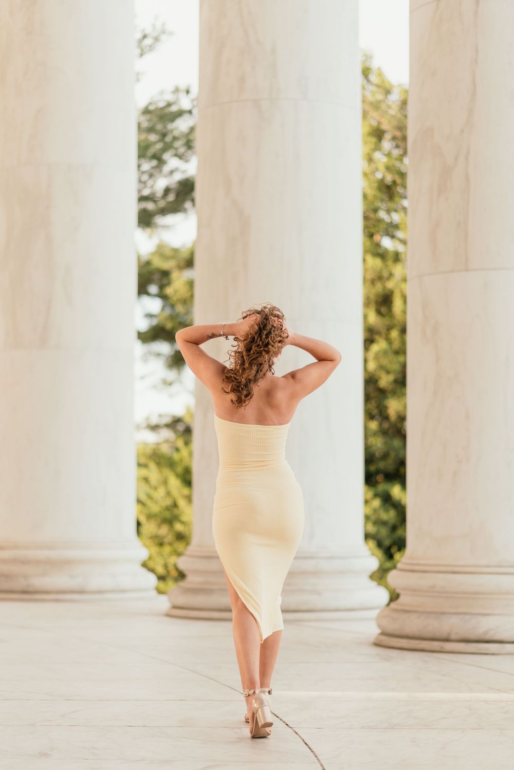 A senior portrait outside at the Jefferson Memorial in Washington D.C. featuring morning golden light.