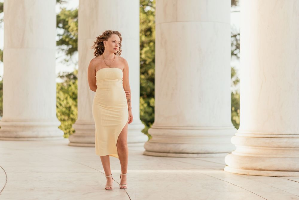 A senior portrait outside at the Jefferson Memorial in Washington D.C. featuring morning golden light.