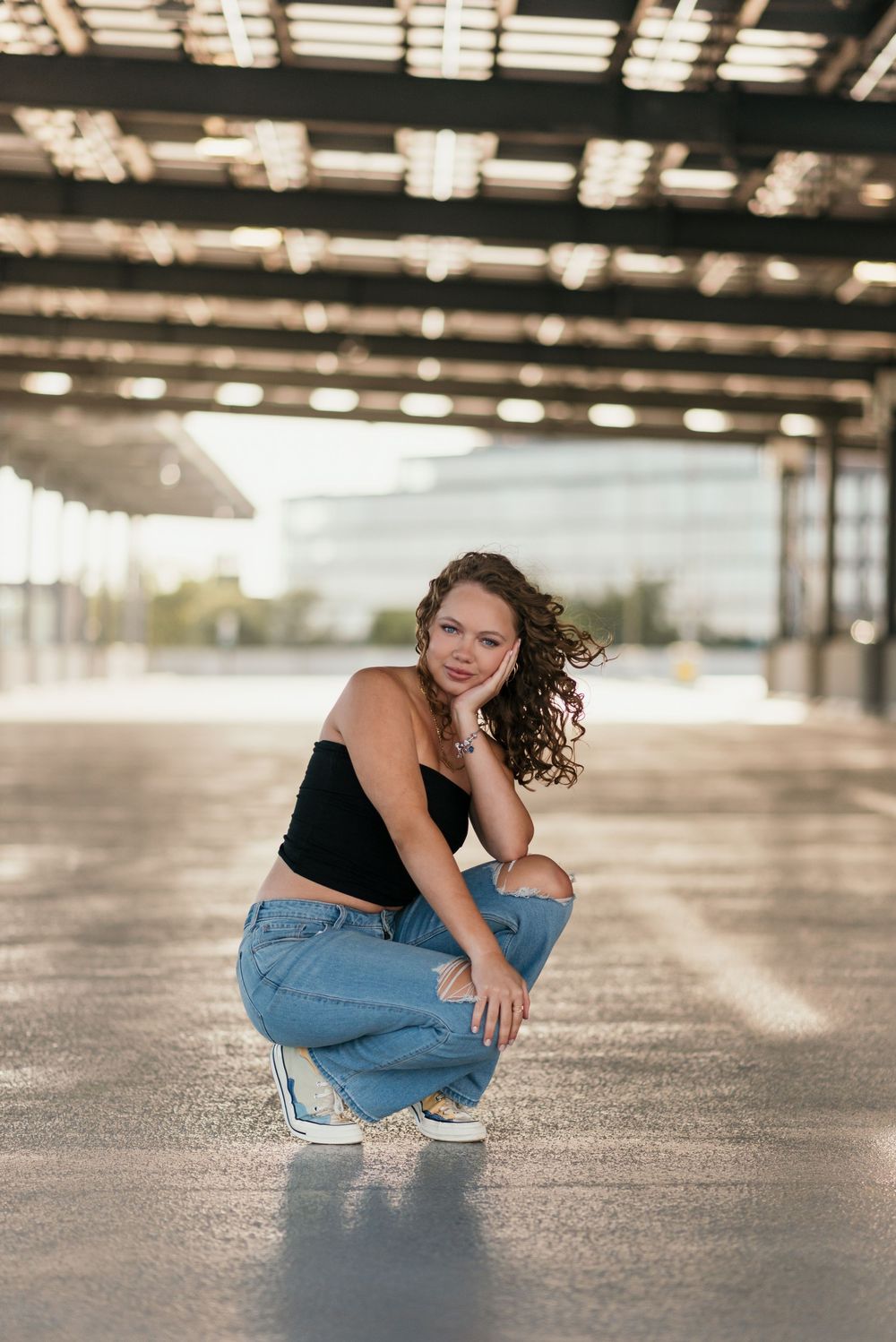 A senior portrait outside in a parking garage in Washington D.C. featuring morning golden light.