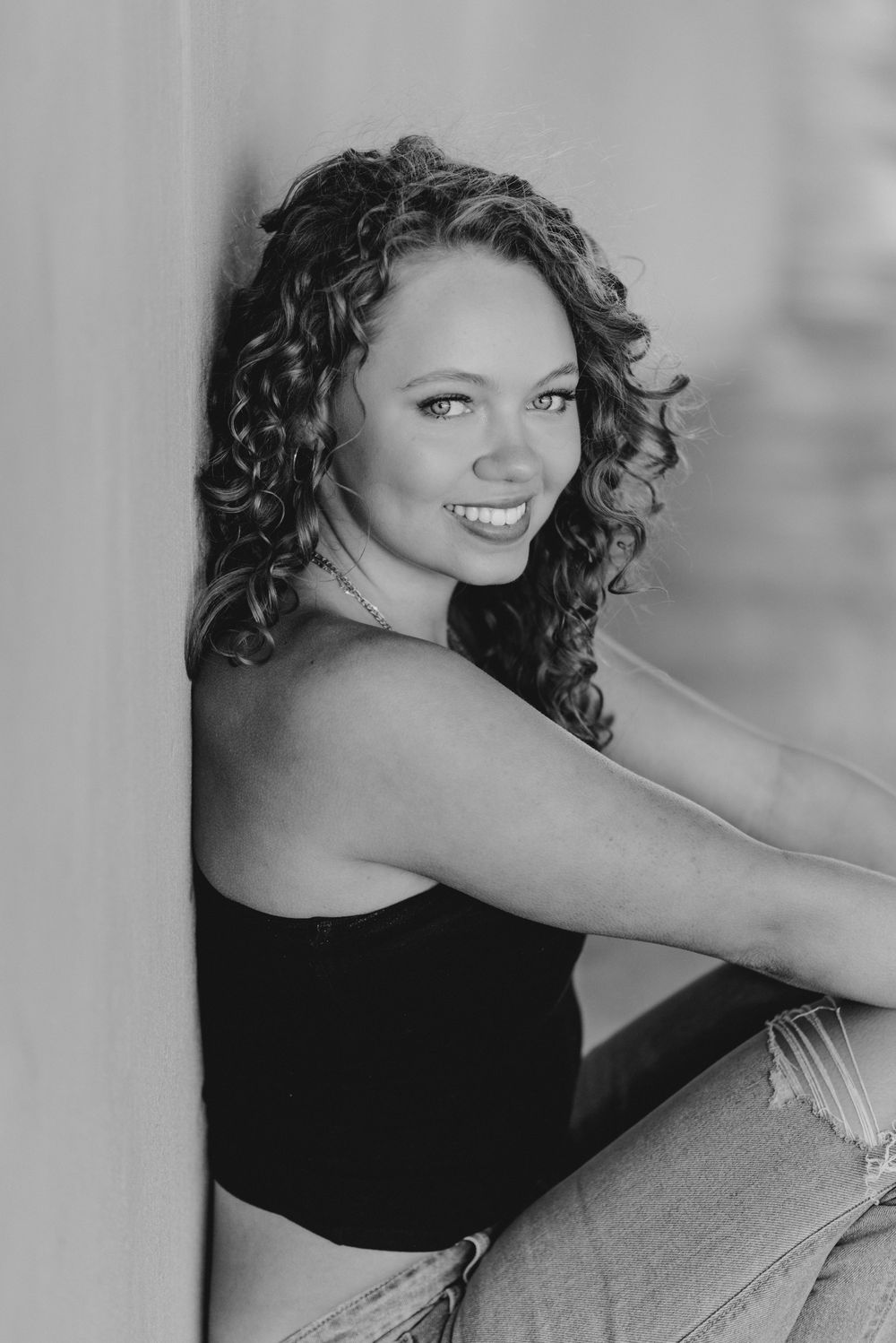 A senior portrait outside in a parking garage in Washington D.C. featuring morning golden light.