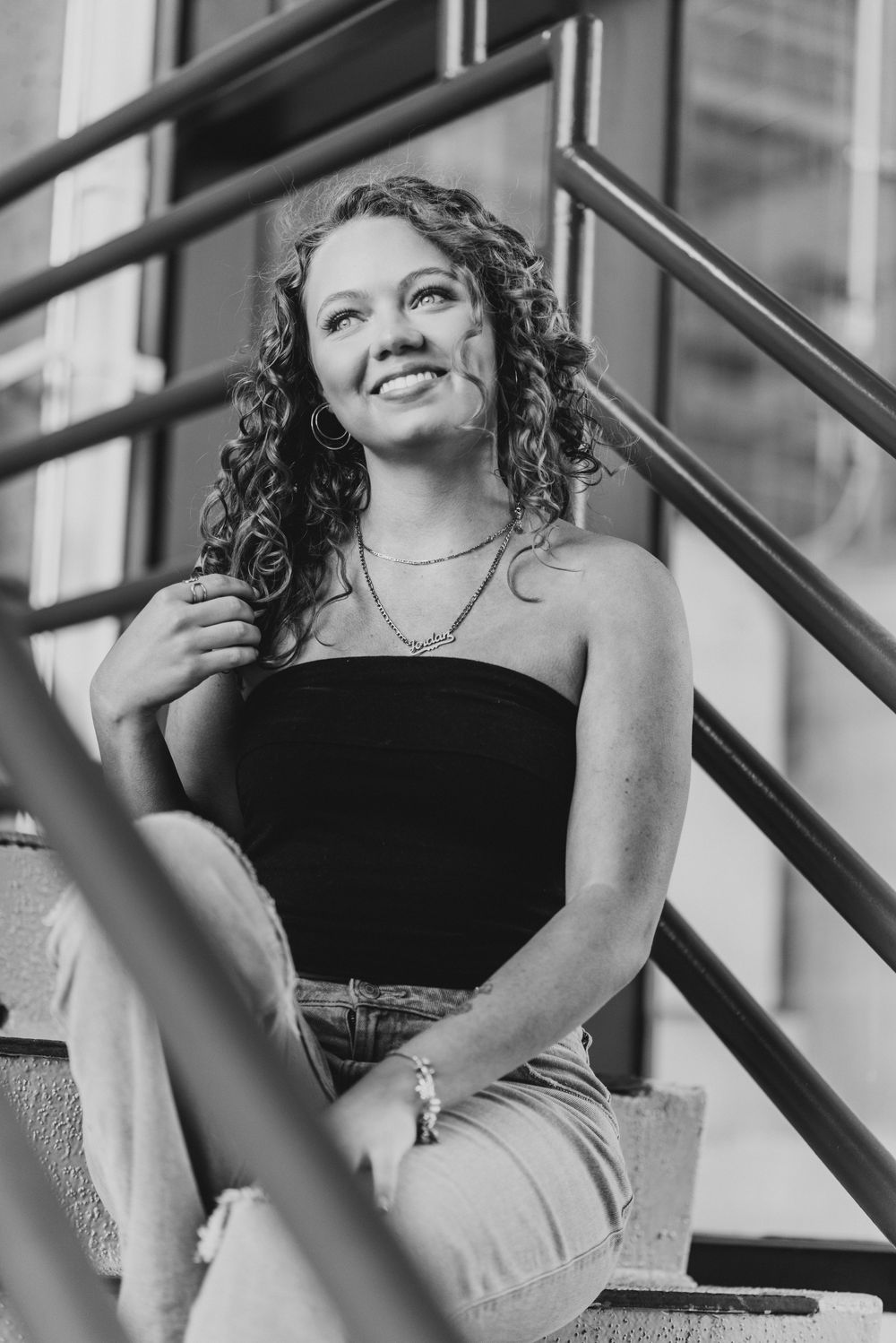 A senior portrait outside in a parking garage in Washington D.C. featuring morning golden light.