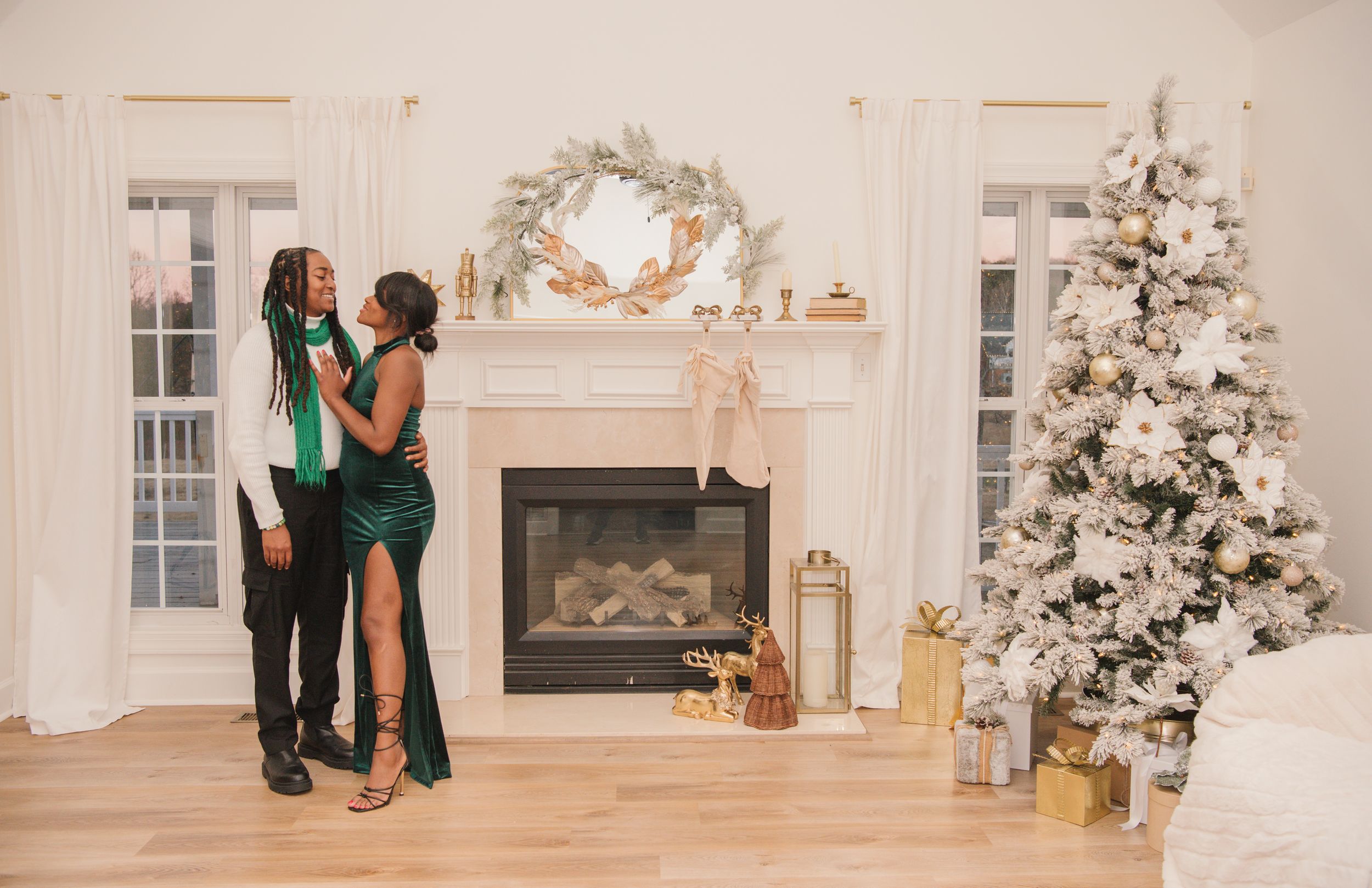 A series of romantic proposal moments captured in an elegant white room with flocked Christmas trees and holiday decor.