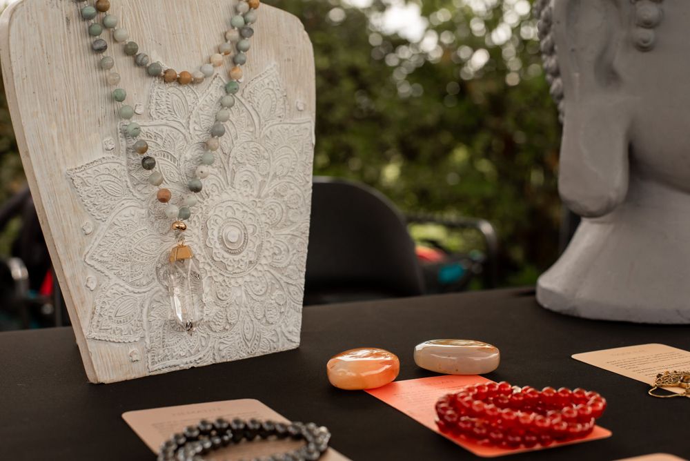 Close-up of necklace displays with crystals and beads on black surface.