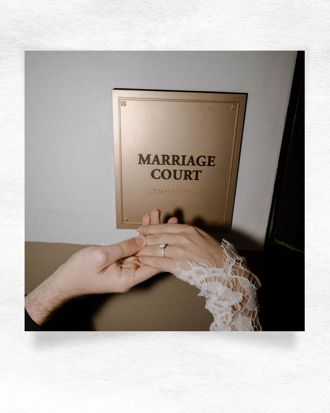 A close-up photo showing hands with a wedding ring next to a Marriage Court document against a beige background.