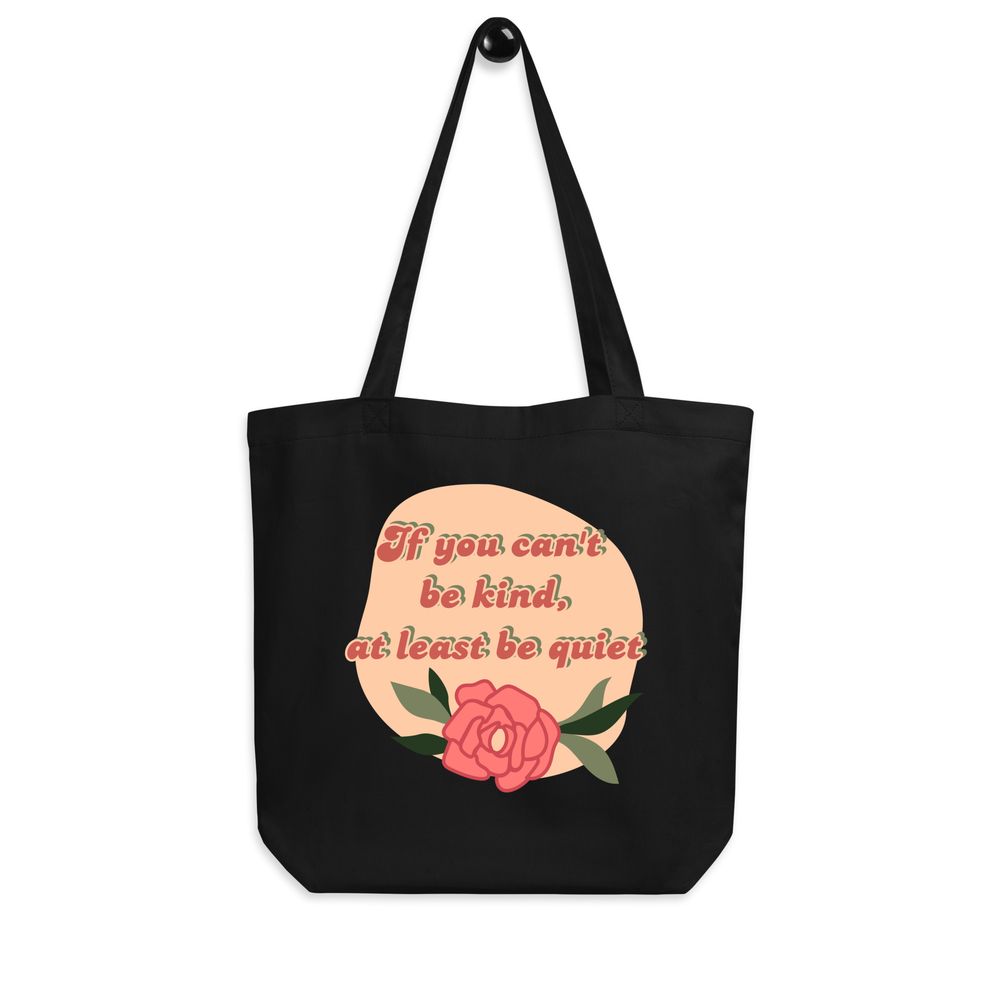 Black canvas tote bag with pink speech bubble design and text about kindness.