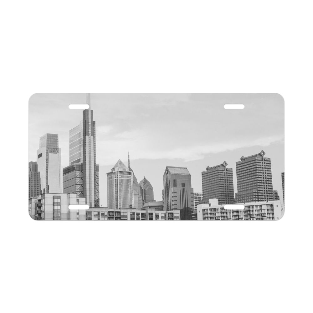Panoramic cityscape of Chicago's iconic skyline with multiple modern skyscrapers and buildings set against a bright sky.