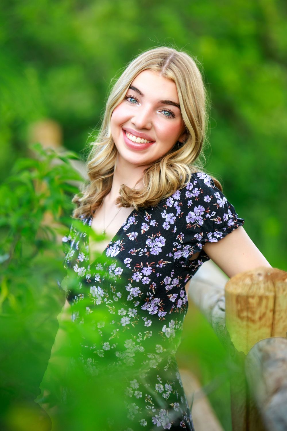 A floral dress complements the lush green garden setting on a bright sunny day.