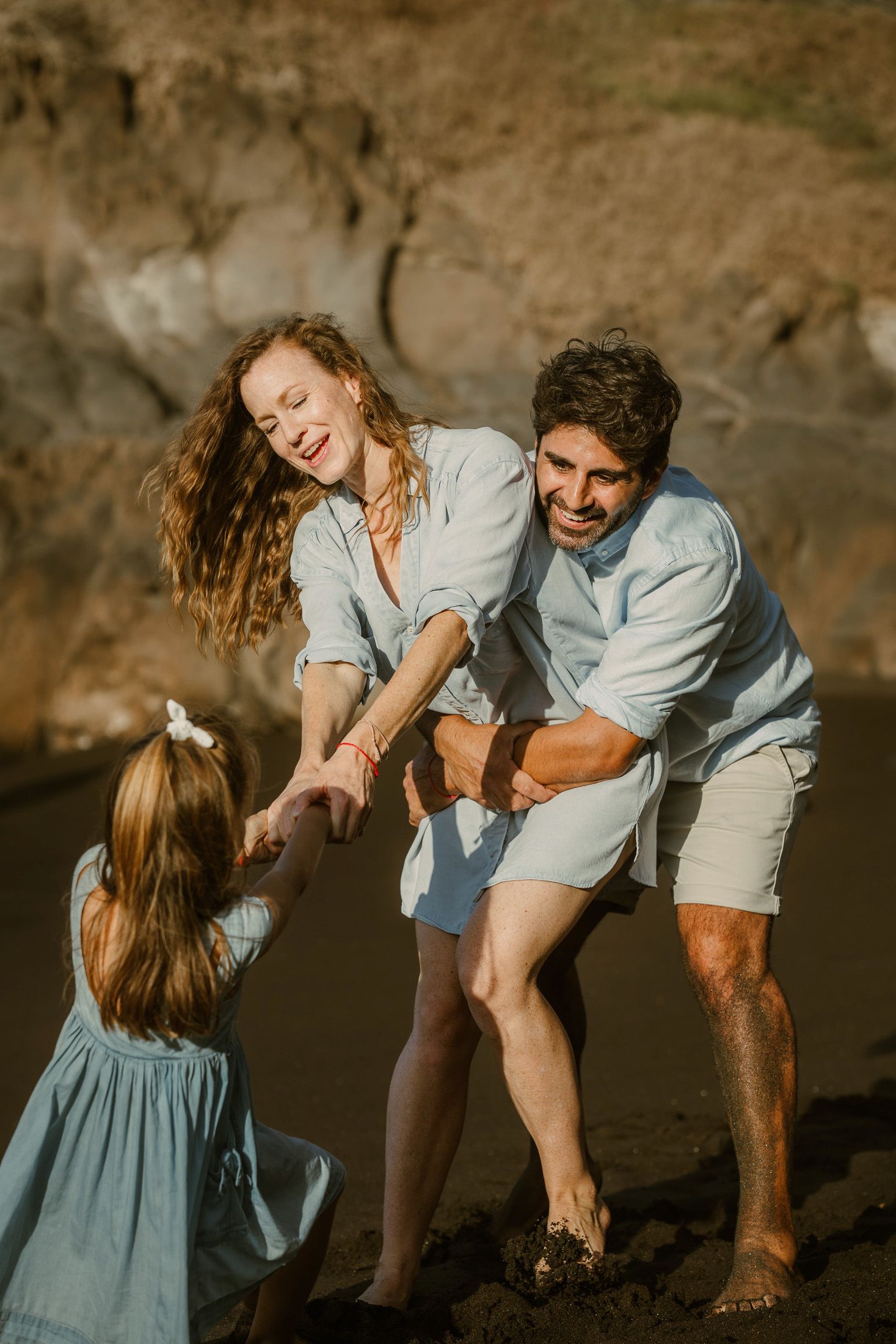 A heartwarming family photoshoot at Playa Bollullo, Tenerife, Canary Islands. Capturing joyful moments by the stunning ocean backdrop.