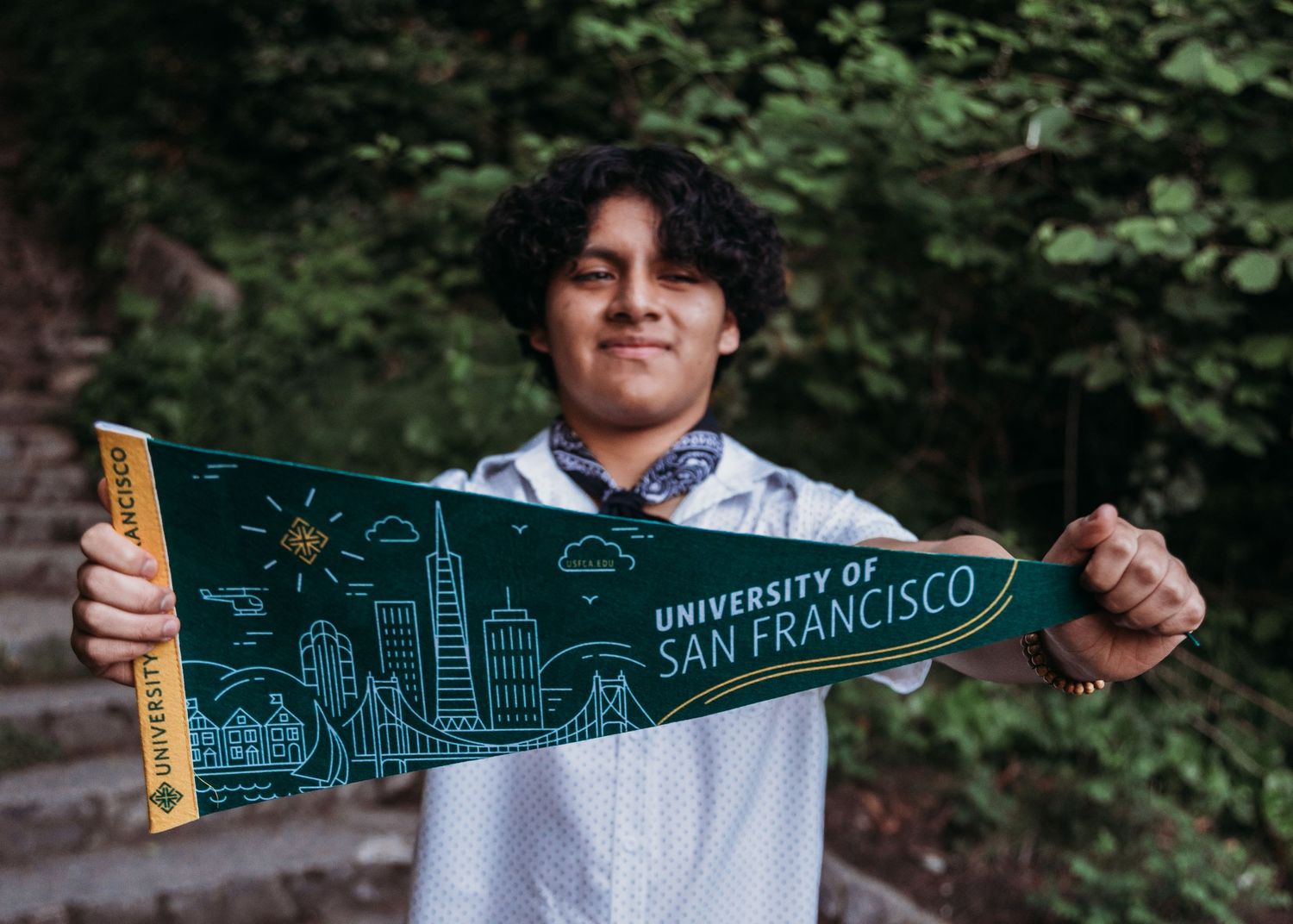 A series of six images showing someone holding various college pennants and merchandise outdoors.