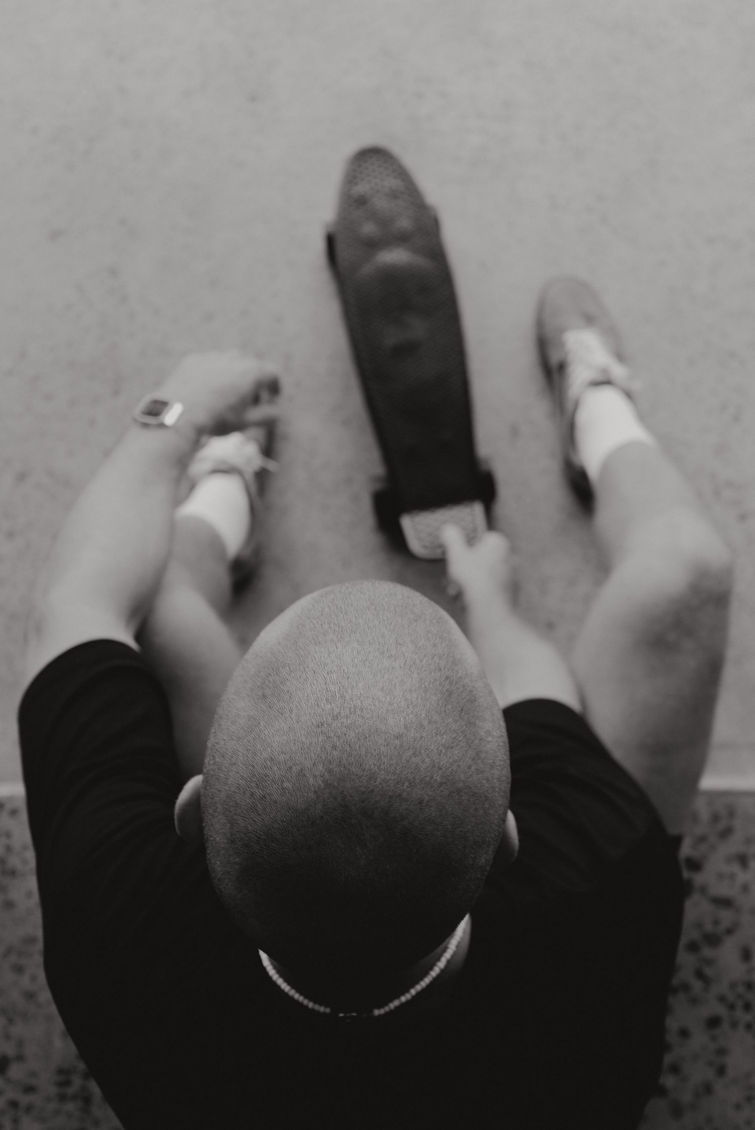 A sequence of black and white photographs showing feet and legs in different positions against a light background.