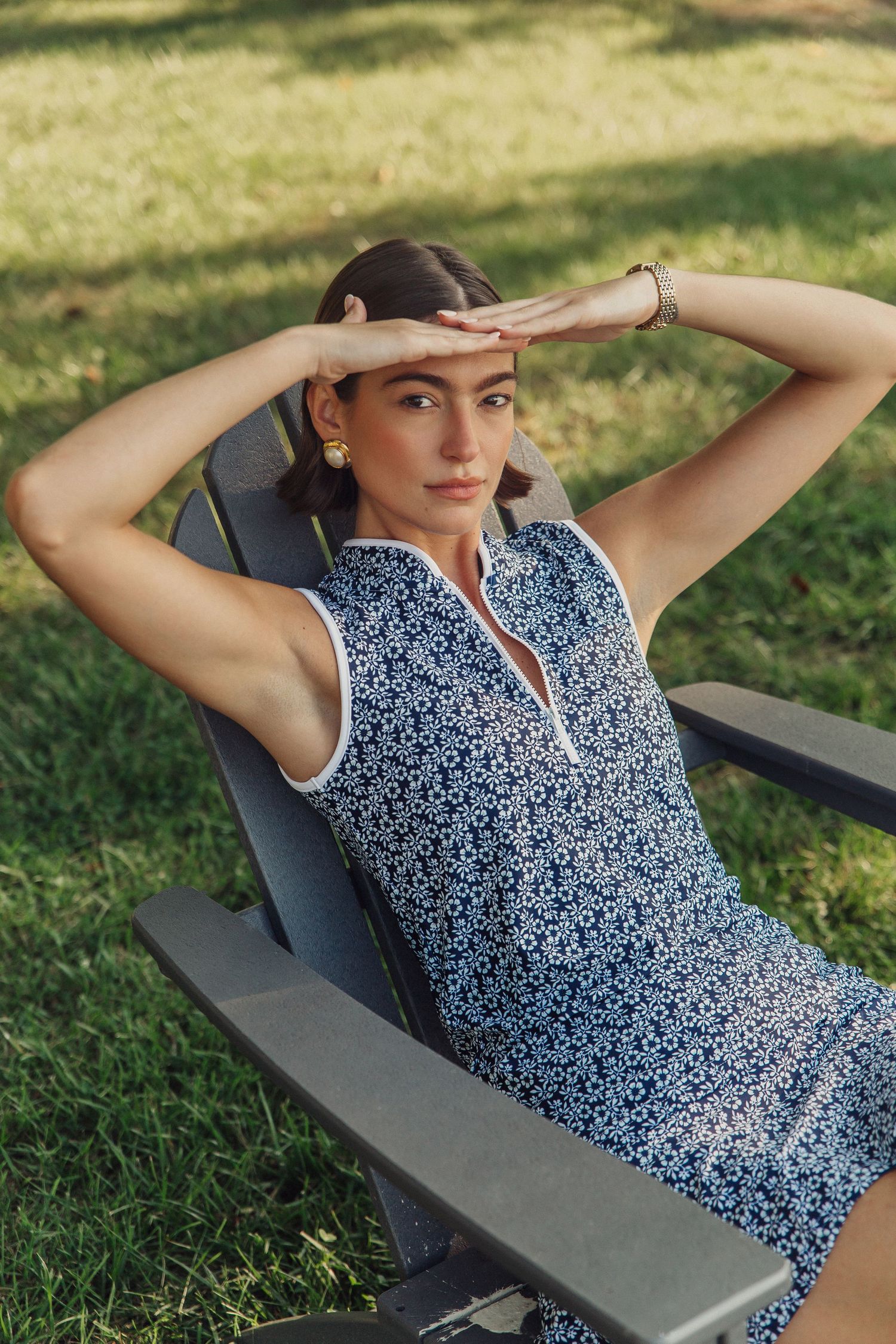 Model Haylee Michalski relaxing in Adirondack chair at Queenstown Harbor Golf Resort, Tennis fashion photography for Smith & Quinn