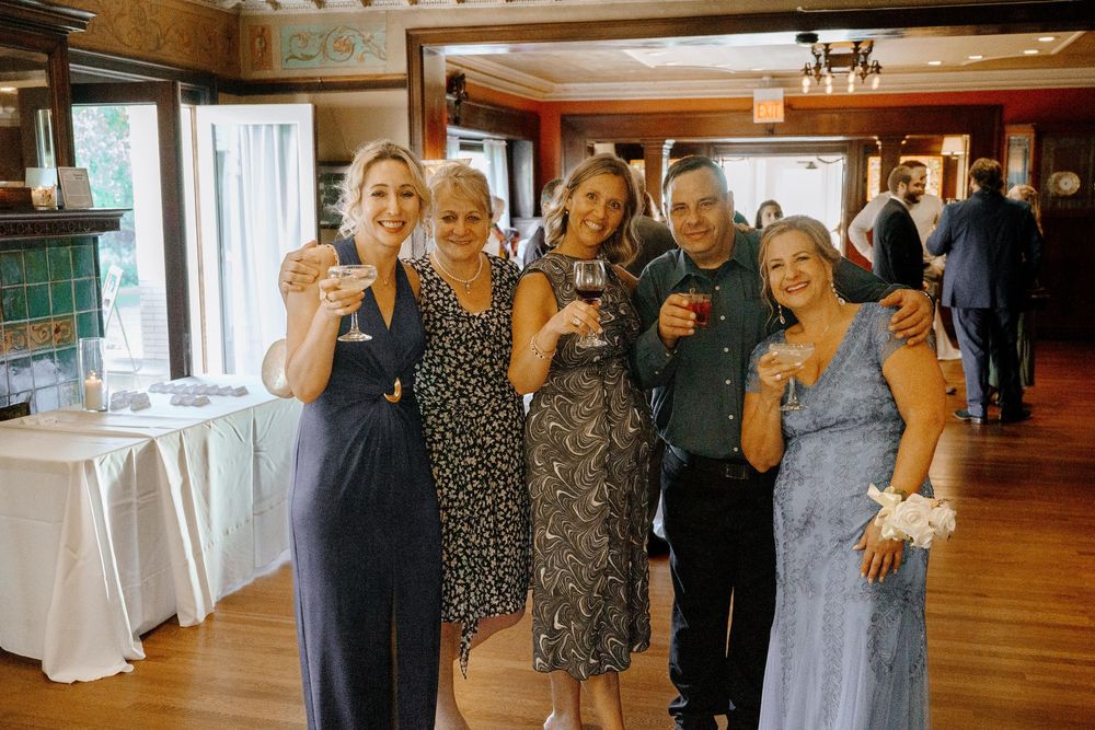 A group of people dancing and enjoying themselves at a social gathering in a banquet hall.