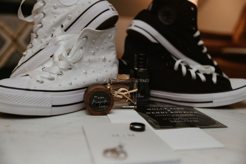 White Converse sneakers styled with wedding details and black stationery.