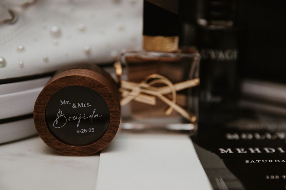 Artistic wedding detail shot with dark moody lighting and elegant stationery.