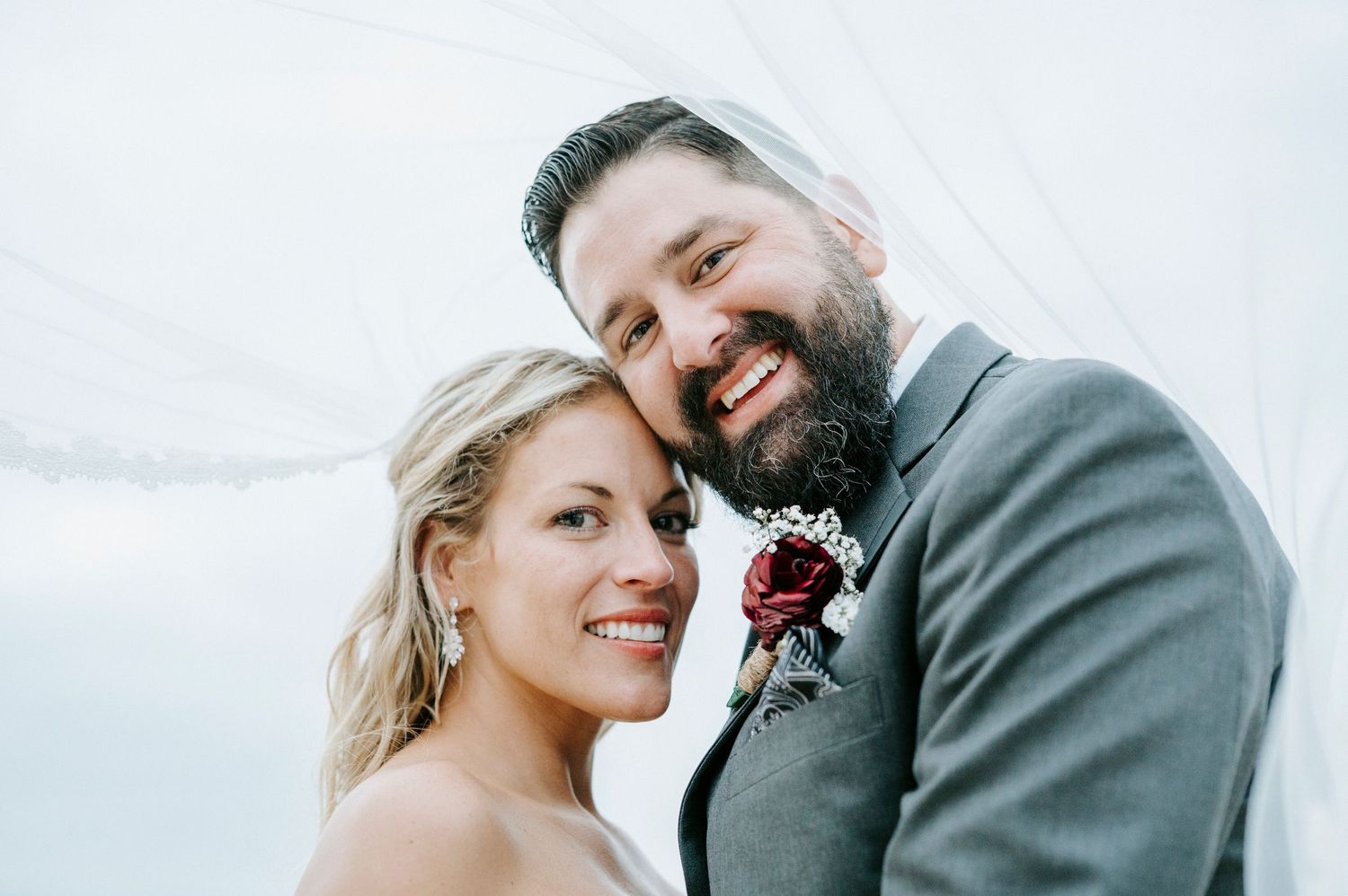 Close-up candid shots of newlyweds sharing intimate moments outdoors.