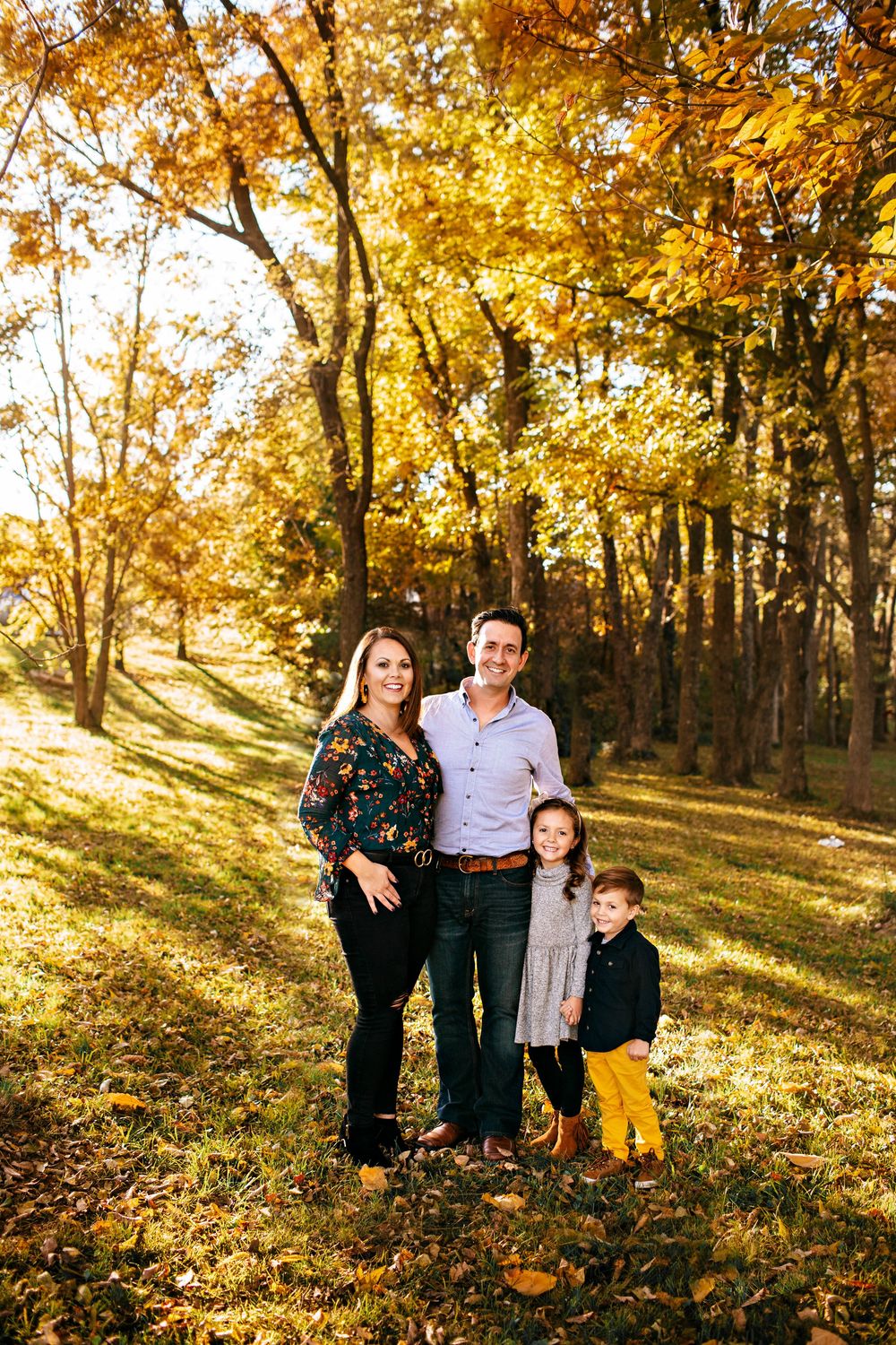 Family portrait in colorful leaves during golden hour - Springfield Missouri Photographer.