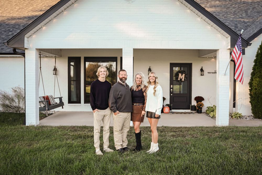Evening family portrait in front of white home in Springfield MO