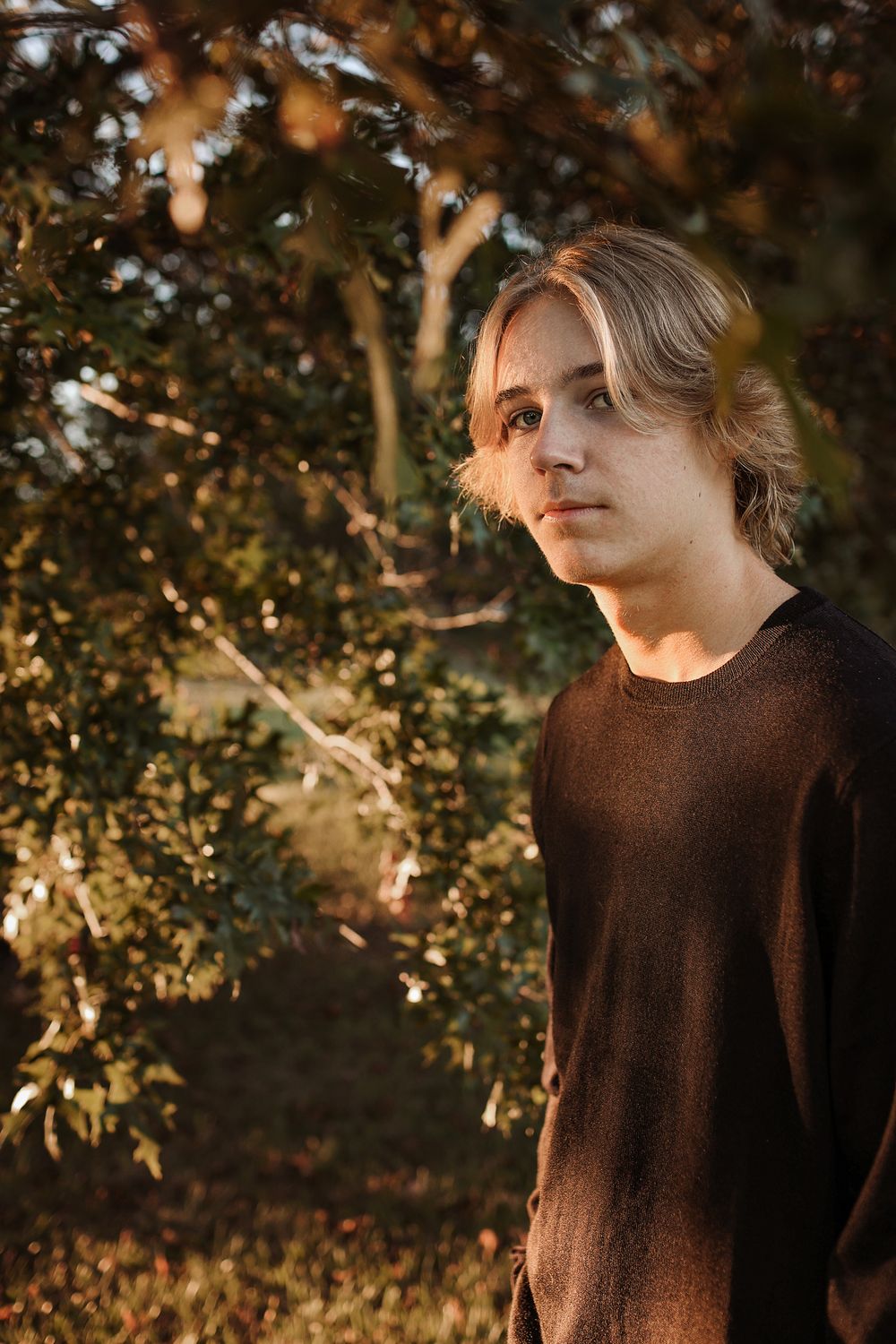 Teenage boy wearing black sweater fall portrait in Springfield MO