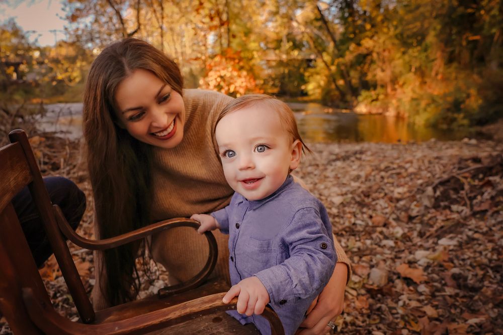 Little boy holding antique chair with mom in Springfield MO