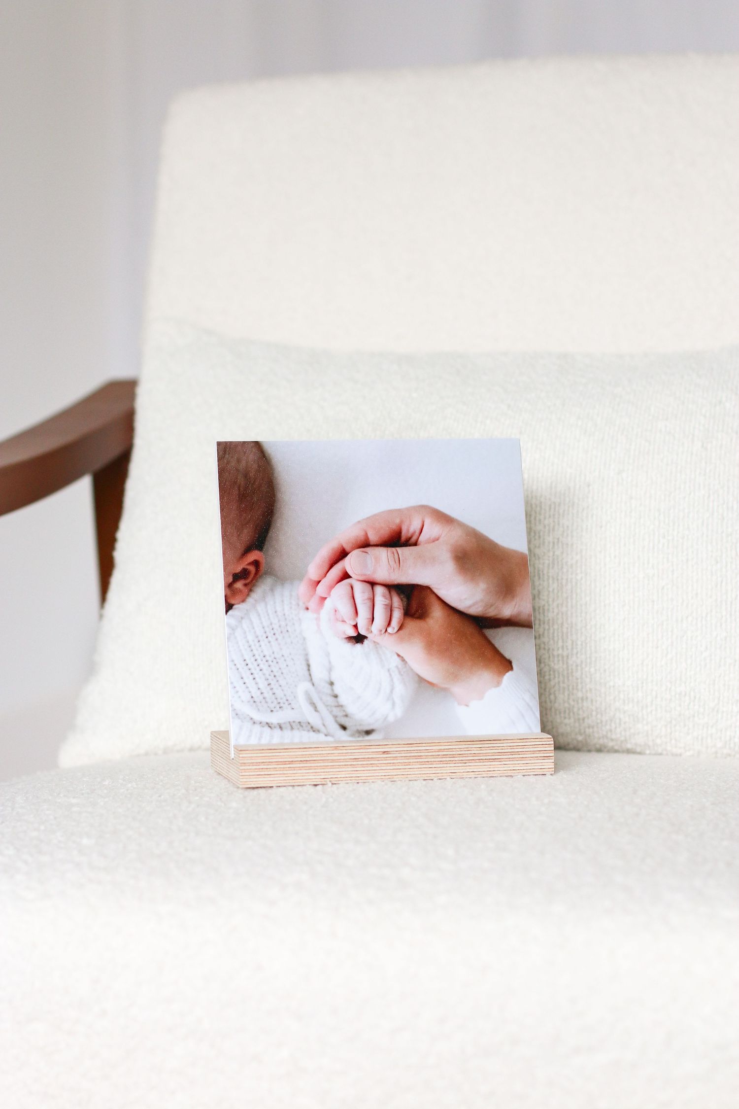 Family hands holding each others on a wooden photo desk display, Nottingham family Photographer