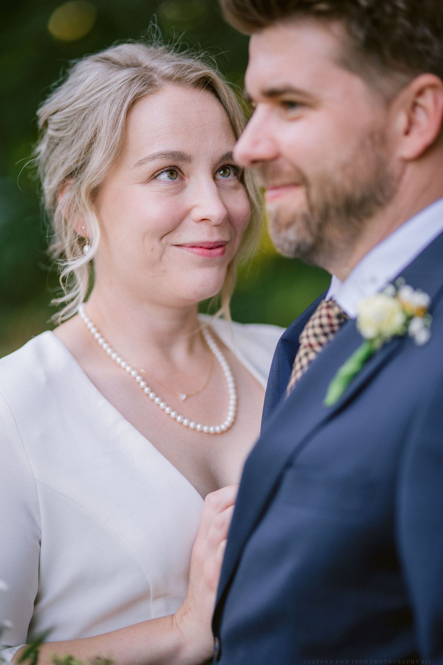 Close-up portrait of newlyweds sharing an intimate moment.