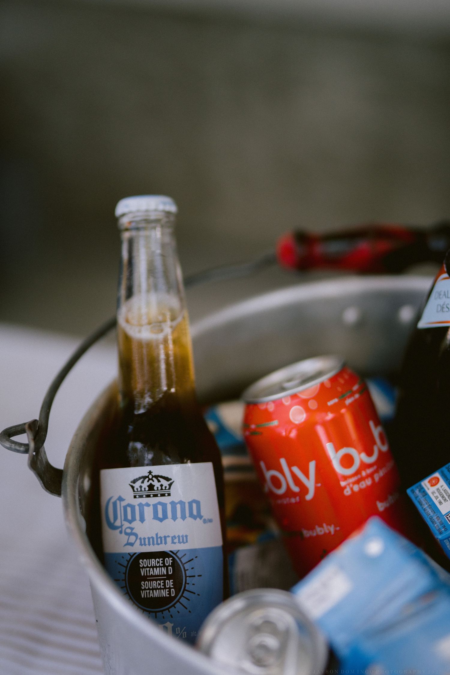 Assorted beverages including Corona beer bottles chilling in ice.