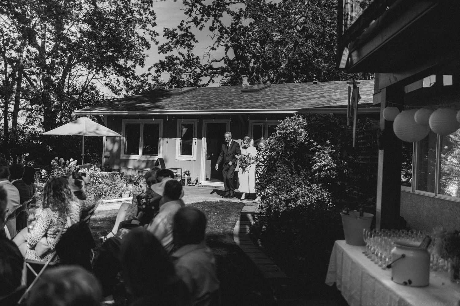 Black and white landscape photo of a residential neighborhood with trees and houses.