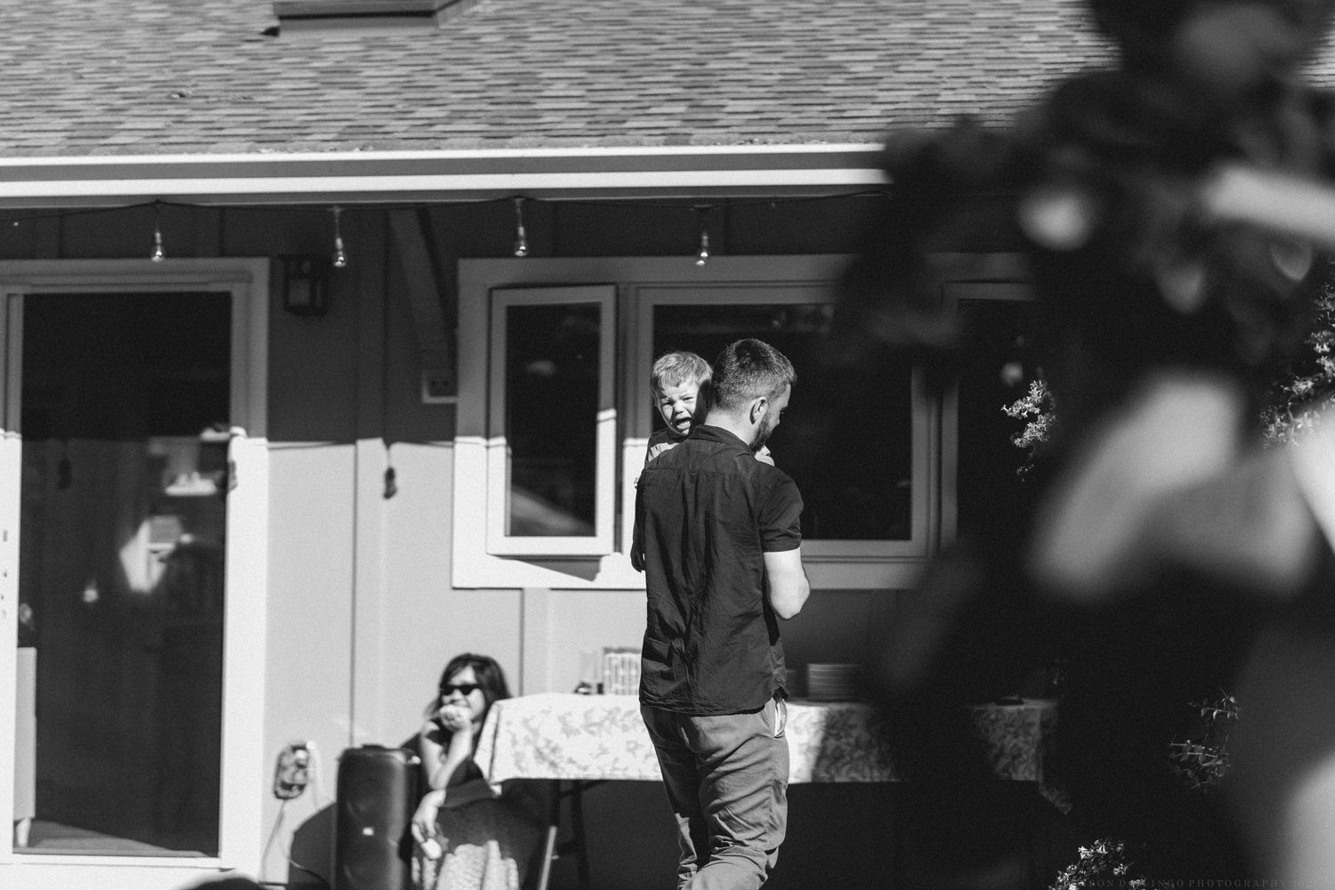 Black and white exterior view of a residential home with architectural details.