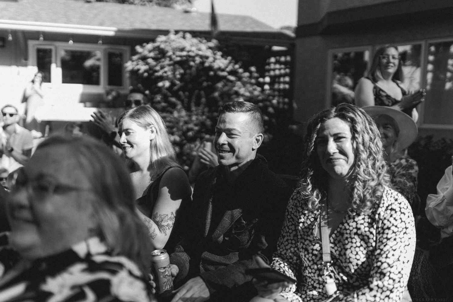 Large group of guests at an outdoor social event.