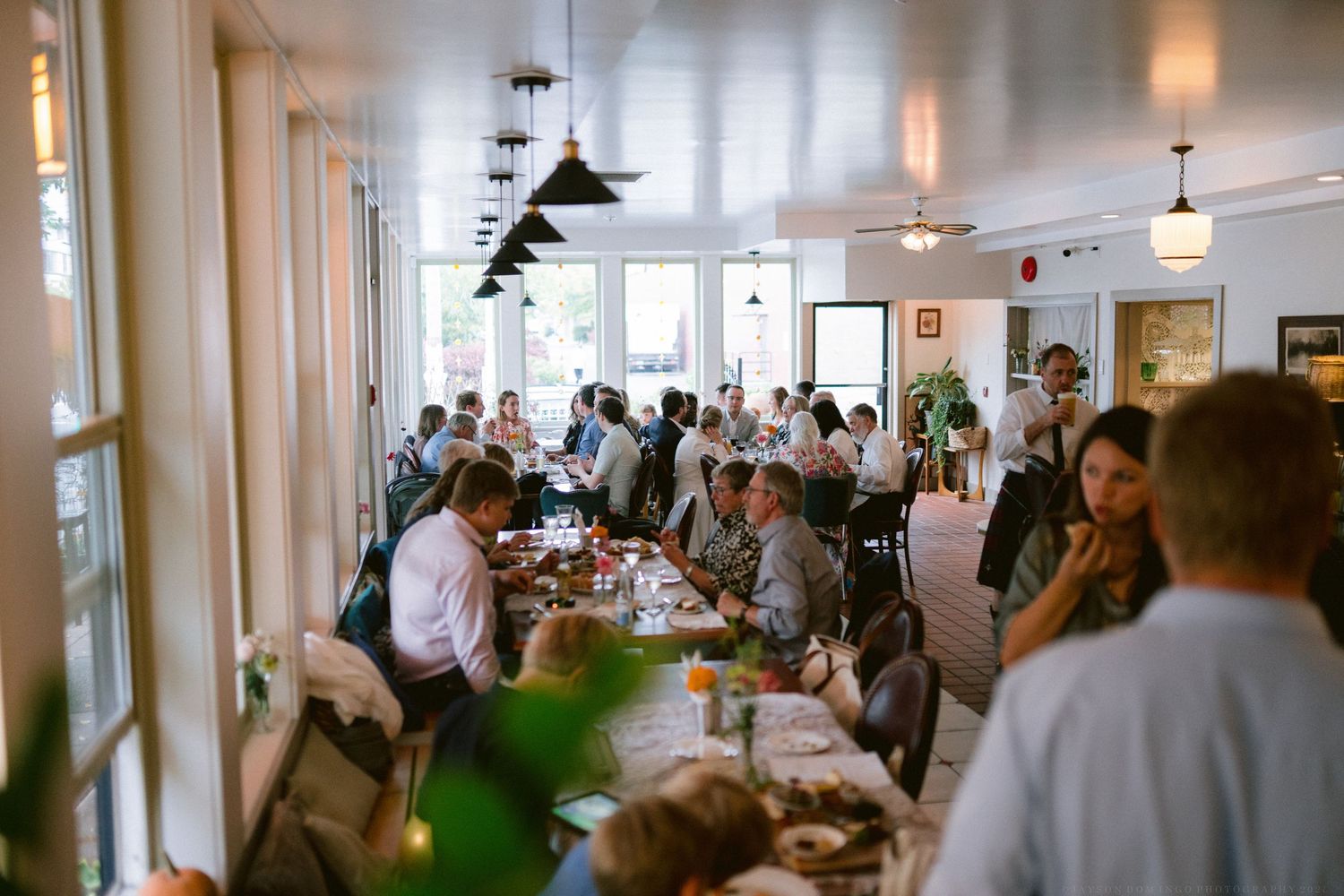 Crowded indoor venue with guests mingling during a social gathering.