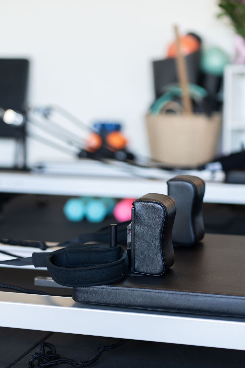 Close-up view of black exercise equipment pads on a dark surface in a fitness setting.