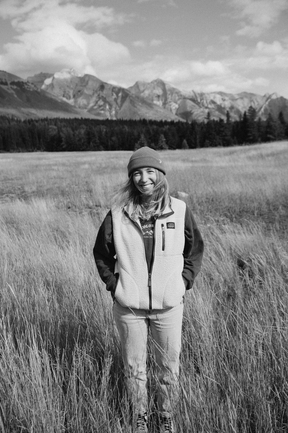Black and white landscape portraits in a mountain meadow with dramatic peaks in the background.